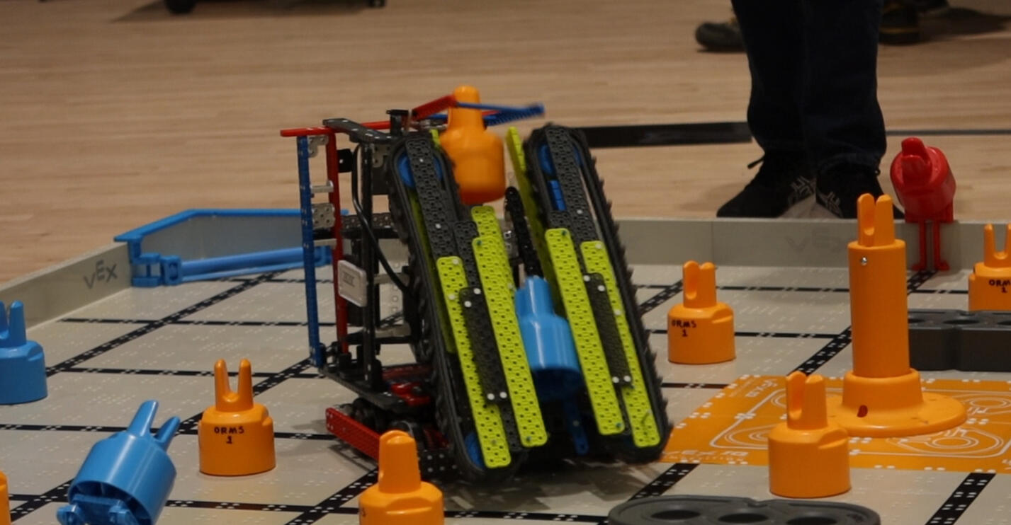 Our Robot made with Vex IQ parts collecting and stacking game objects in a match